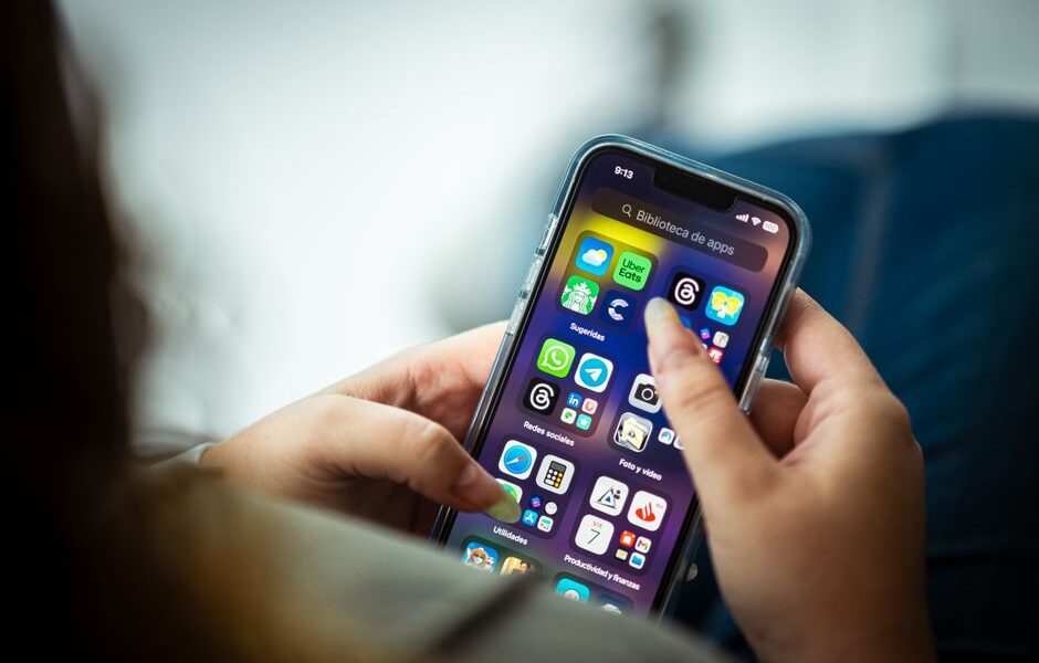 A person checking a cash back rewards app on their smartphone while shopping