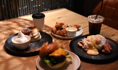 A spread of classic American comfort food dishes including mac and cheese, fried chicken, and apple pie on a wooden table