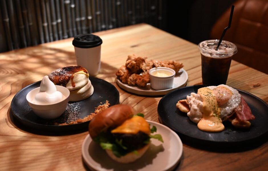 A spread of classic American comfort food dishes including mac and cheese, fried chicken, and apple pie on a wooden table