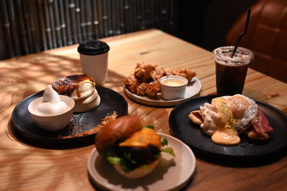 A spread of classic American comfort food dishes including mac and cheese, fried chicken, and apple pie on a wooden table