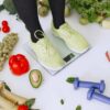 A spread of healthy weight loss foods including vegetables, eggs, nuts, and fruit