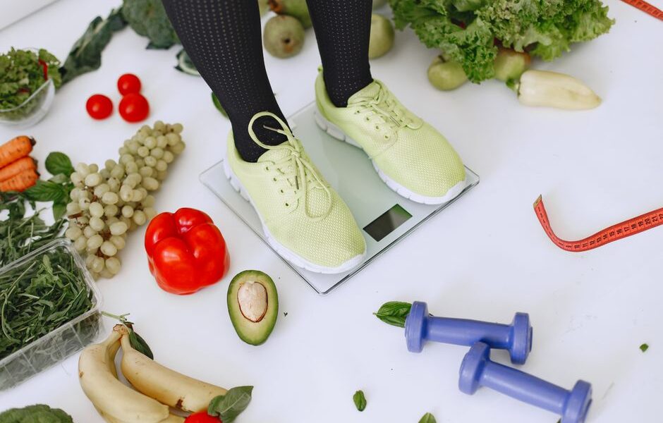 A spread of healthy weight loss foods including vegetables, eggs, nuts, and fruit
