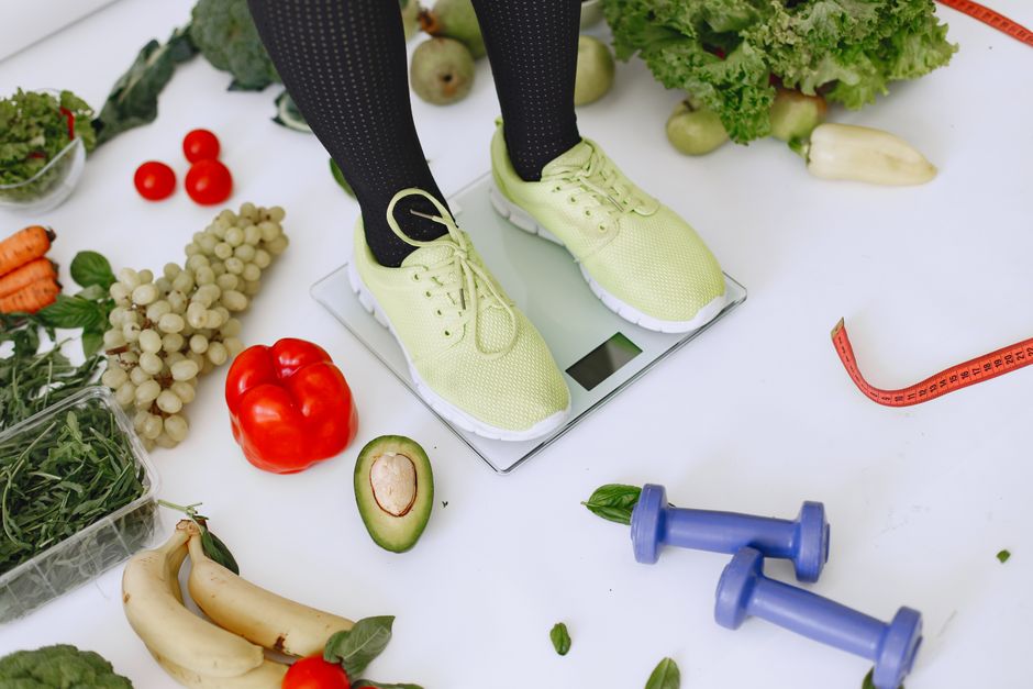 A spread of healthy weight loss foods including vegetables, eggs, nuts, and fruit