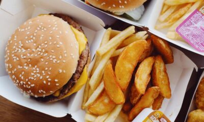 A tray of popular American fast food including a burger, fries, and a soft drink