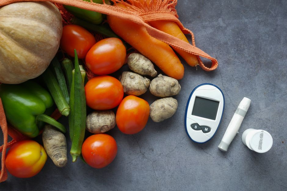 A variety of healthy foods including leafy greens, berries, nuts, and legumes known to help lower blood sugar naturally