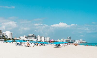 Aerial view of a luxury beach resort along the Florida coastline with turquoise water and white sand