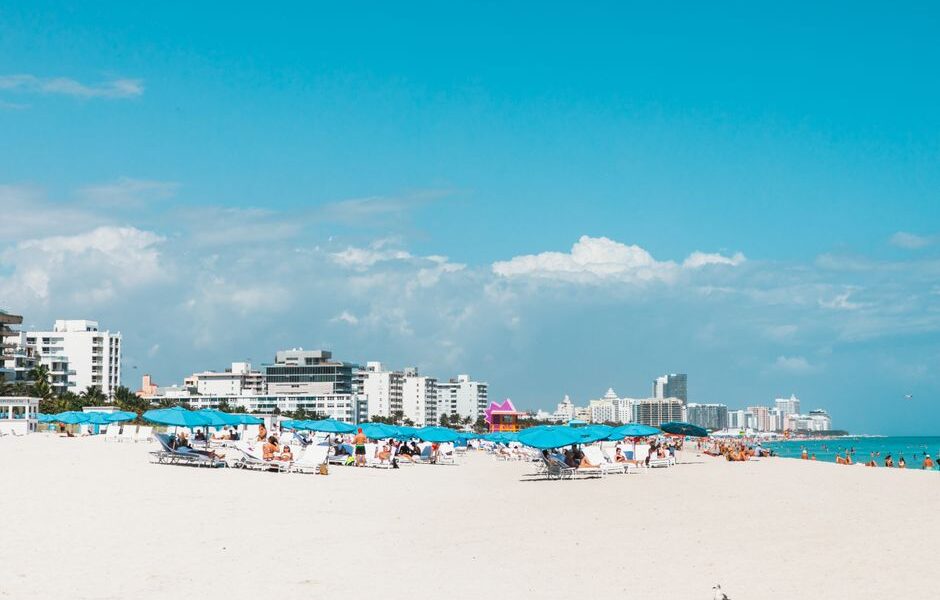 Aerial view of a luxury beach resort along the Florida coastline with turquoise water and white sand