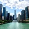 Affordable budget hotel building in downtown Chicago with city skyline in the background