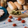 Backyard Fourth of July BBQ spread with grilled food, fresh fruit, and patriotic decorations