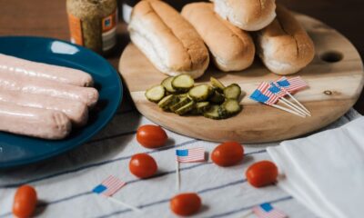 Backyard Fourth of July BBQ spread with grilled food, fresh fruit, and patriotic decorations