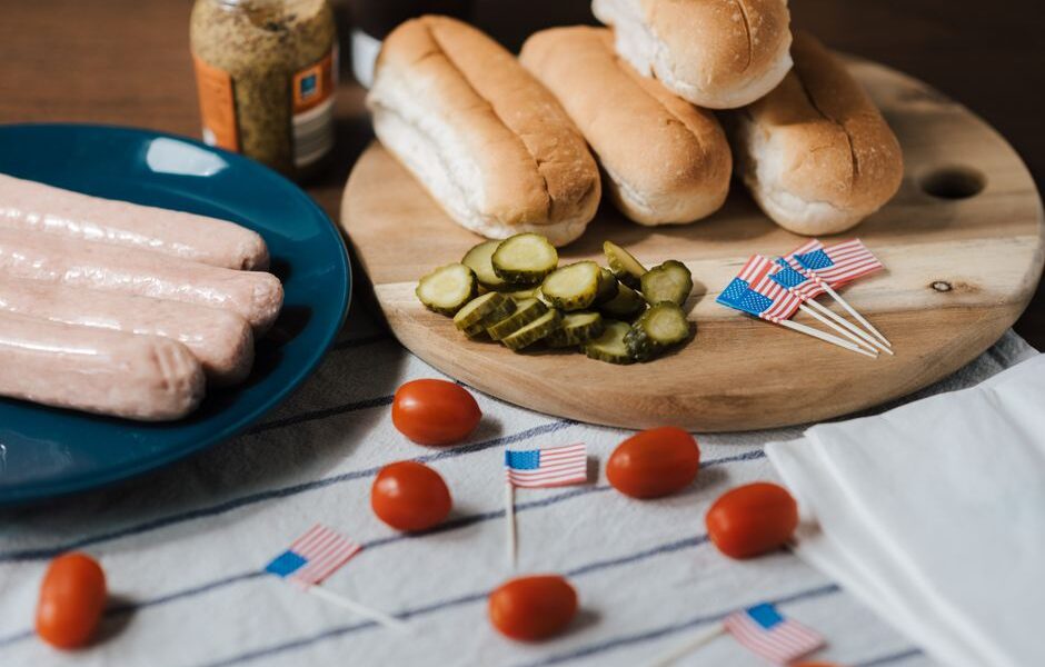 Backyard Fourth of July BBQ spread with grilled food, fresh fruit, and patriotic decorations