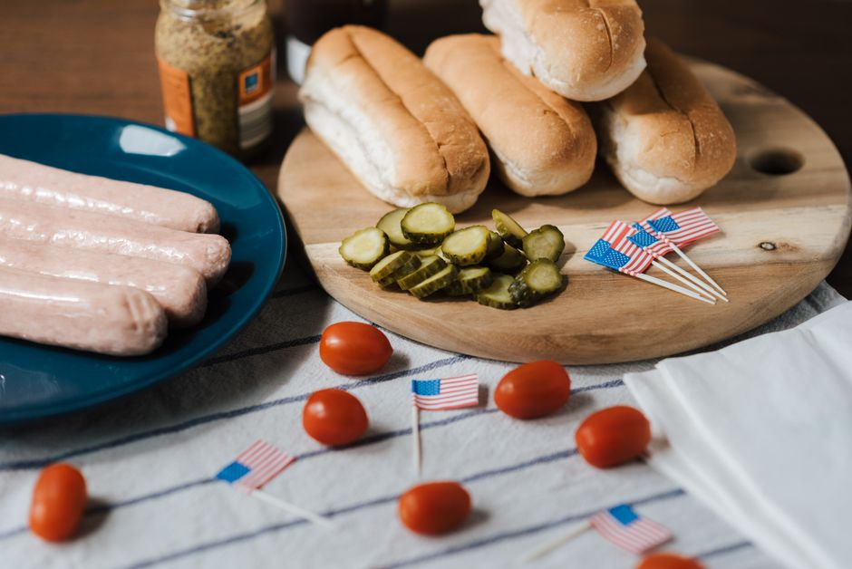Backyard Fourth of July BBQ spread with grilled food, fresh fruit, and patriotic decorations