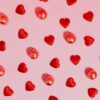 Collection of affordable Valentine's Day gifts under $50 including candles, jewelry, and a photo book arranged on a table