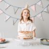 Colorful kids birthday party setup with balloons, decorations, and a cake table