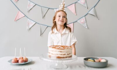 Colorful kids birthday party setup with balloons, decorations, and a cake table