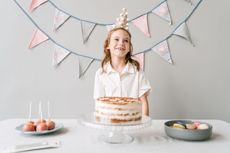 Colorful kids birthday party setup with balloons, decorations, and a cake table