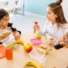 Kids enjoying colorful after-school snacks at a kitchen table