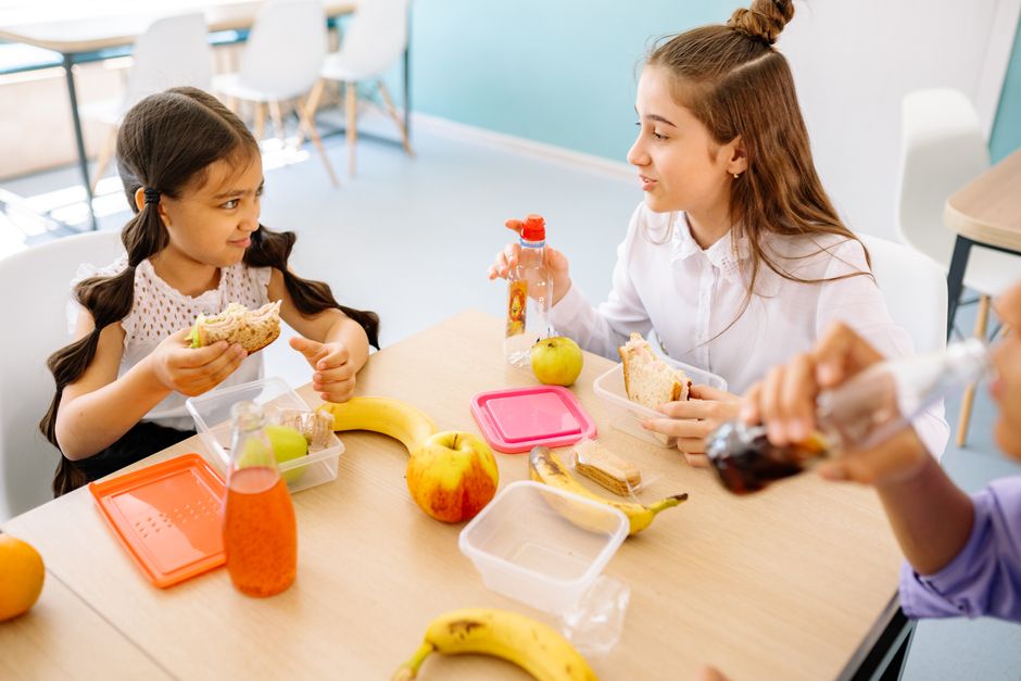 Kids enjoying colorful after-school snacks at a kitchen table