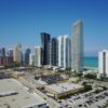 Luxury real estate agent showing an upscale Miami waterfront property to clients
