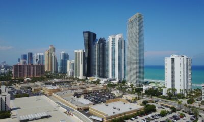 Luxury real estate agent showing an upscale Miami waterfront property to clients