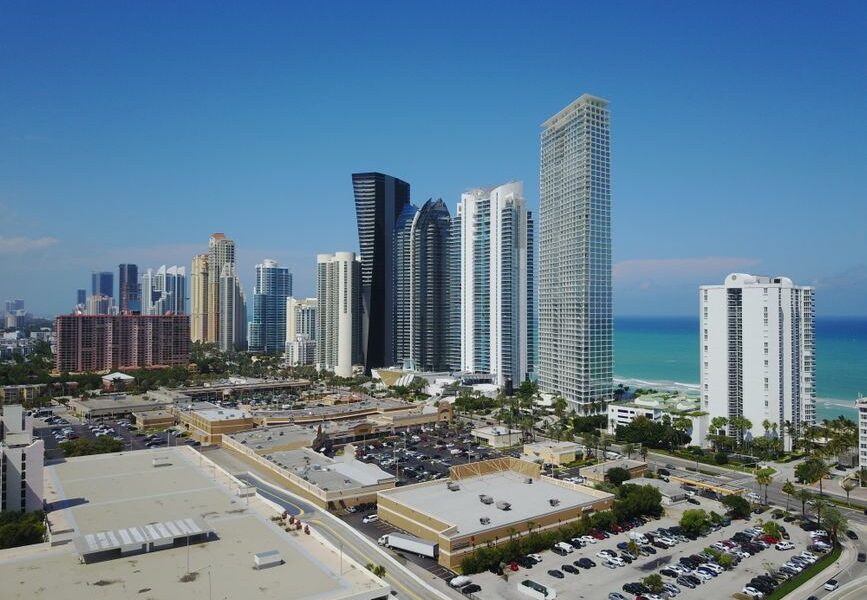 Luxury real estate agent showing an upscale Miami waterfront property to clients
