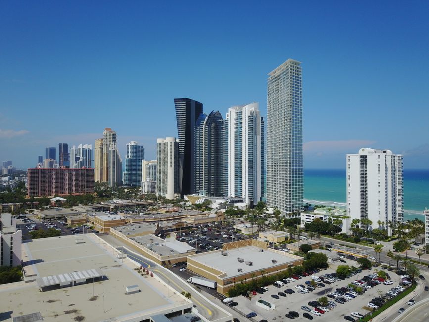 Luxury real estate agent showing an upscale Miami waterfront property to clients