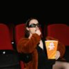 Movie theater seats and screen representing the best movies releasing this summer in USA