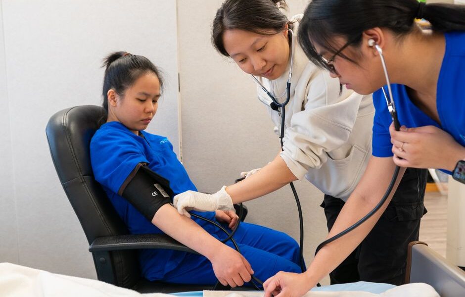 Nursing students studying together in a classroom at a nursing school in New York