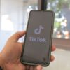 Person browsing TikTok Shop on a smartphone to find the best viral products of 2025
