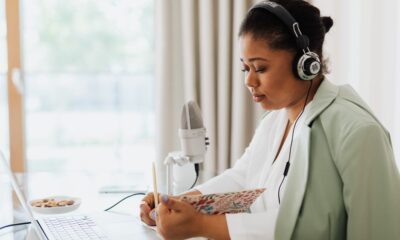 Person listening to a daily podcast using headphones during a commute