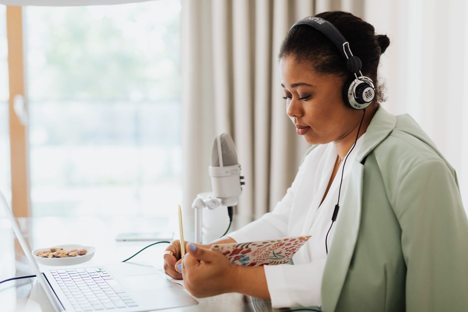 Person listening to a daily podcast using headphones during a commute