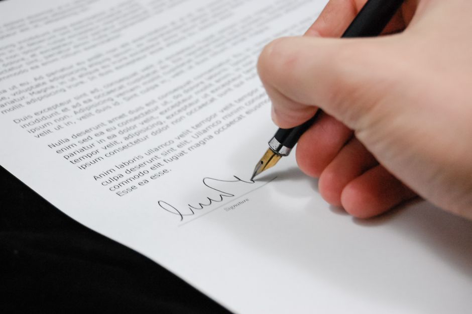 Real estate attorney reviewing property closing documents with clients in New Jersey