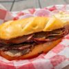 Sliced smoked brisket and ribs on butcher paper at a classic American BBQ restaurant
