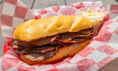 Sliced smoked brisket and ribs on butcher paper at a classic American BBQ restaurant