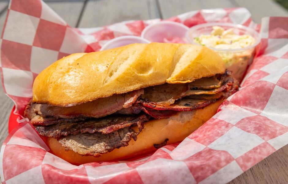 Sliced smoked brisket and ribs on butcher paper at a classic American BBQ restaurant