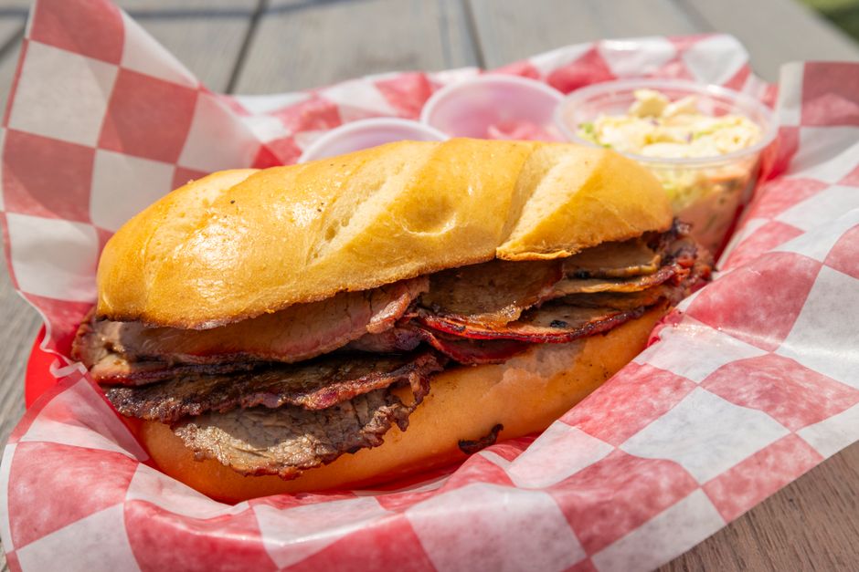 Sliced smoked brisket and ribs on butcher paper at a classic American BBQ restaurant