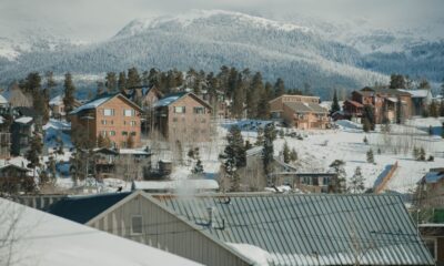 Snow-covered ski slopes and chairlifts at a Colorado ski resort with mountain peaks in the background