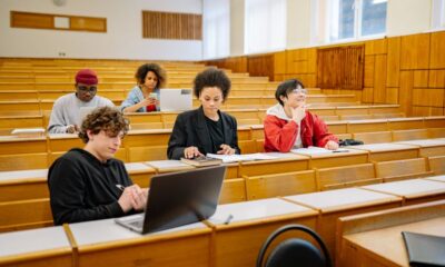 Students working on laptops during a coding bootcamp class in Texas
