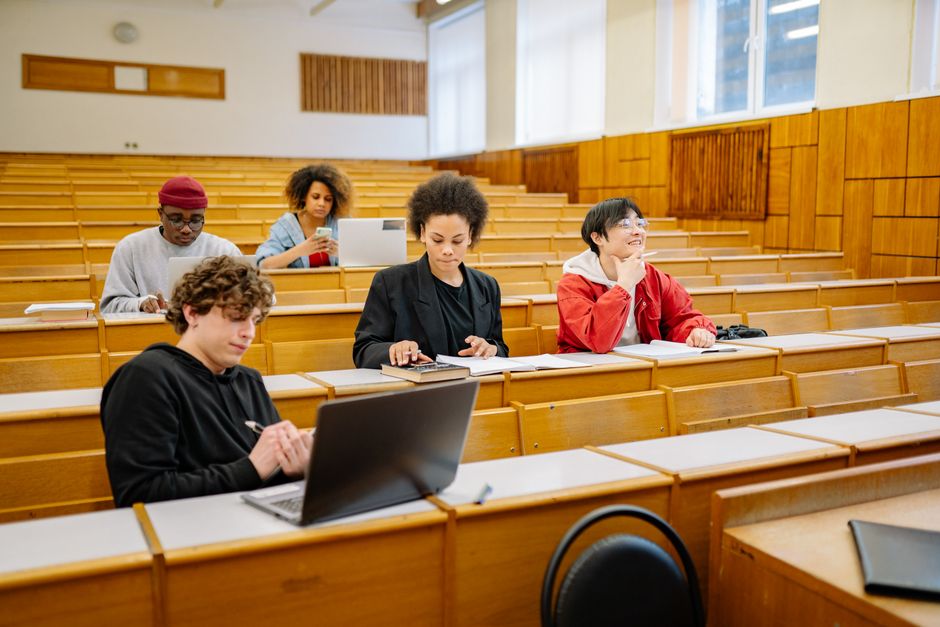 Students working on laptops during a coding bootcamp class in Texas