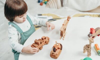 Toddler playing with colorful wooden educational toys on the floor