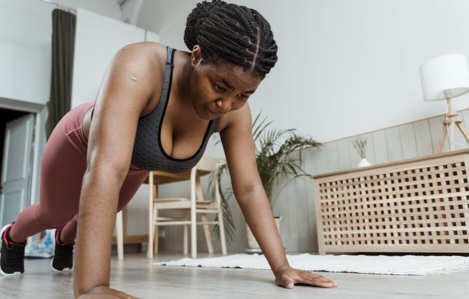 Woman performing push-ups on a yoga mat during a home workout