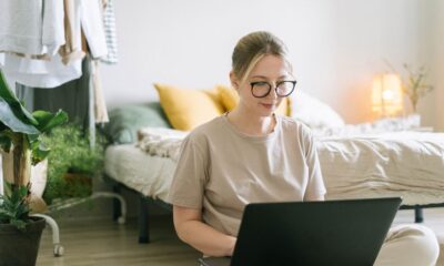 Woman working on a laptop at a home office desk while making money from home