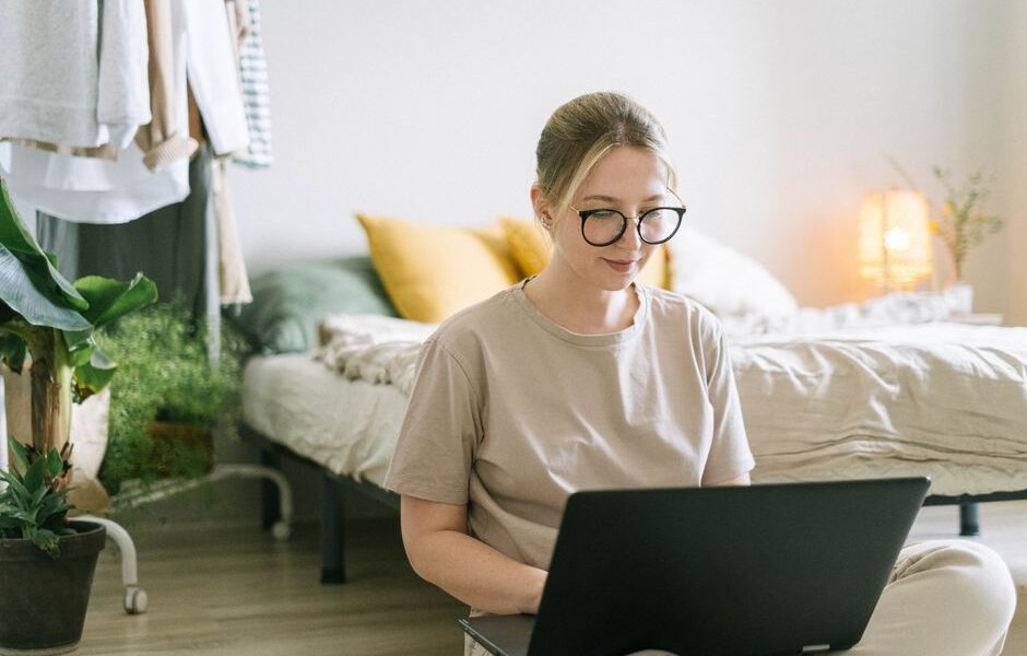 Woman working on a laptop at a home office desk while making money from home