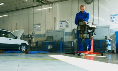 Mechanic repairing a car engine inside an auto repair shop in California
