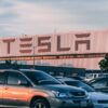 Row of electric vehicles parked outside a California dealership showroom
