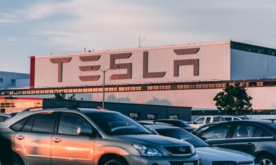 Row of electric vehicles parked outside a California dealership showroom
