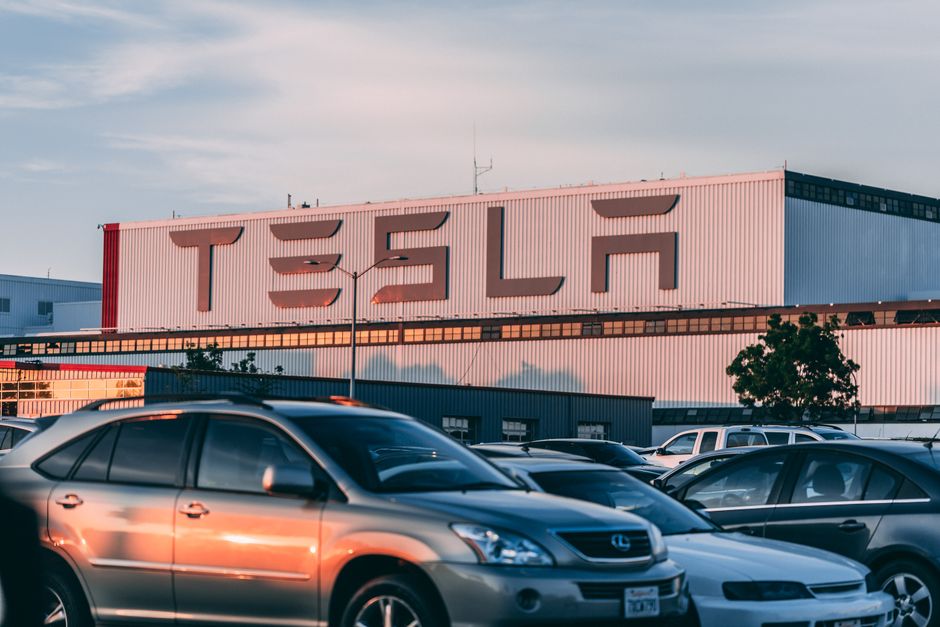 Row of electric vehicles parked outside a California dealership showroom
